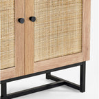 Close-up view of the woven natural cane door panel and black metal base on the oak bookcase