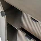 Close-up interior view of the open cupboard door on the fluted storage cabinet showing internal shelf space