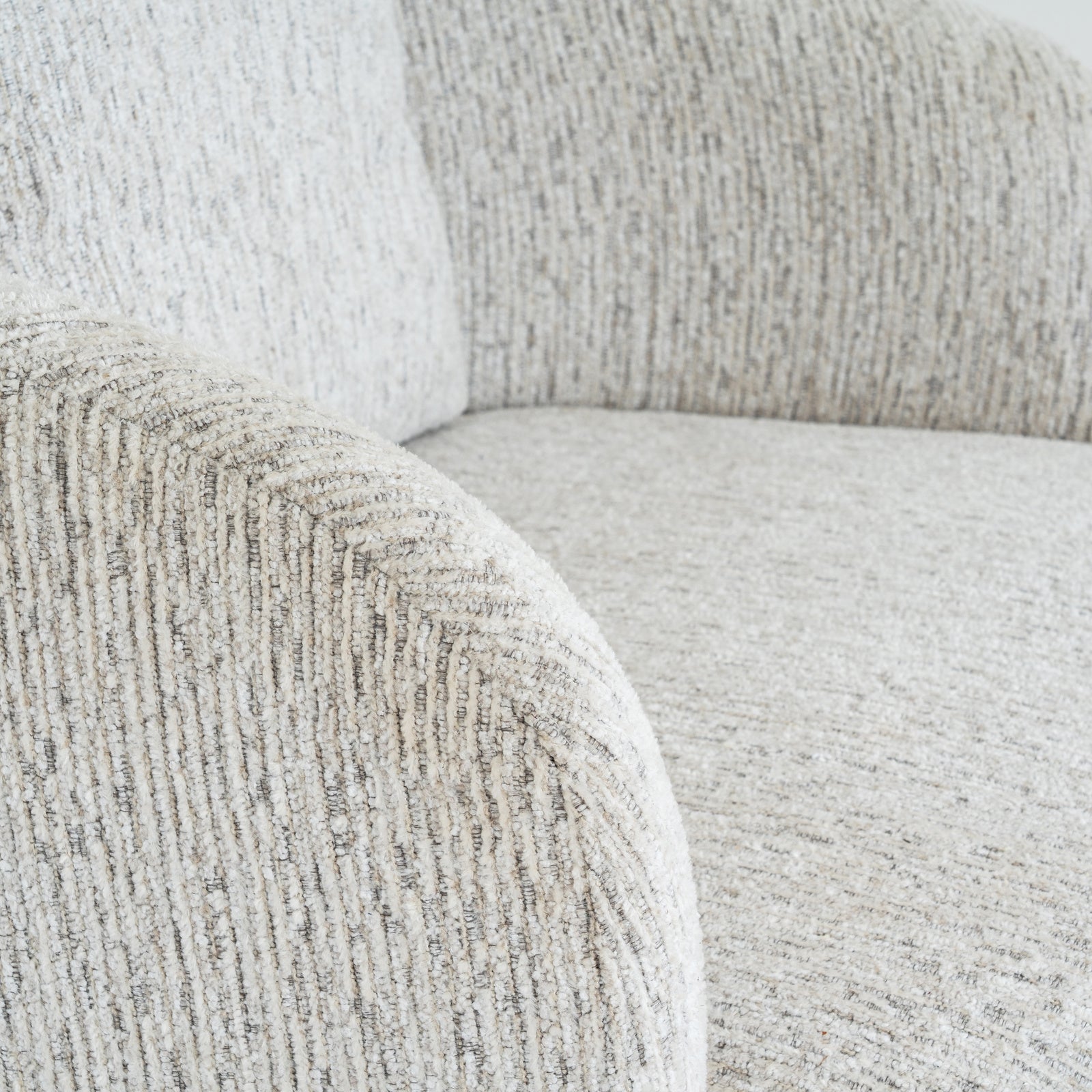 Close-up shot of the soft textured bouclé fabric weave and detailed stitching on the Sorelle swivel chair
