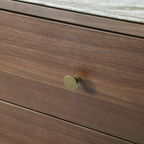 Brass pull hardware detail and black cylindrical leg base on the Willow tobacco walnut dresser