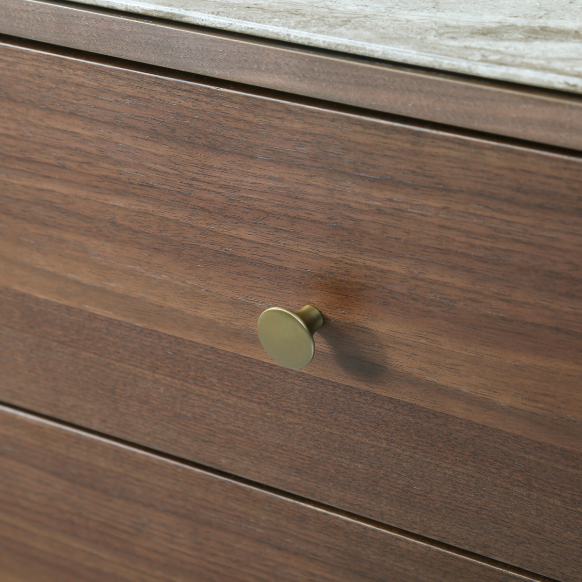 Brass pull hardware detail and black cylindrical leg base on the Willow tobacco walnut dresser