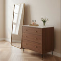 Contemporary tobacco walnut bedroom chest featuring three soft-close drawers and slender black cylindrical legs