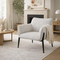 Zephra Upholstered Accent Chair styled in a modern living room setting with a side table and throw blanket.