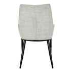 Rear view showing the high contoured backrest and black leg frame of the Zephra Dining Chair.