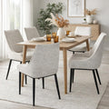 Set of Zephra Upholstered Dining Chairs styled around a light wood dining table.